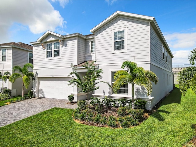 view of front of home featuring a garage and a front lawn