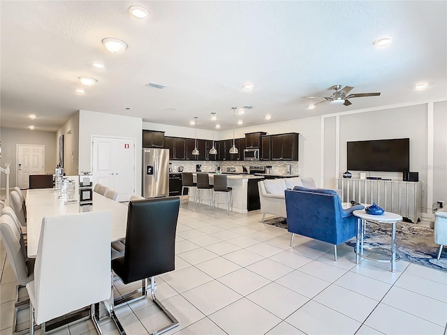 dining space with light tile patterned flooring and ceiling fan