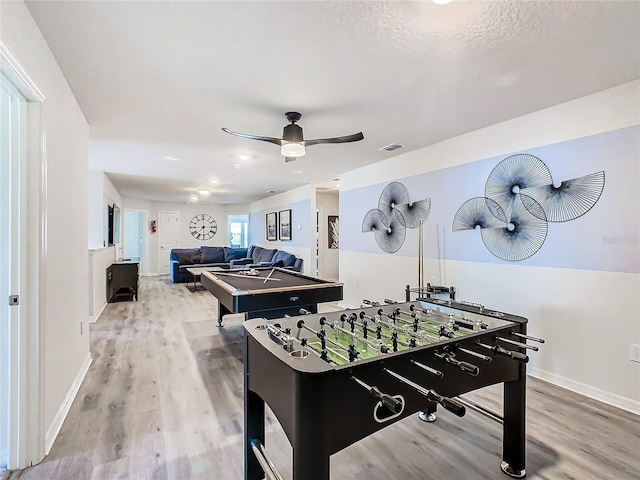 rec room featuring ceiling fan, hardwood / wood-style flooring, and a textured ceiling