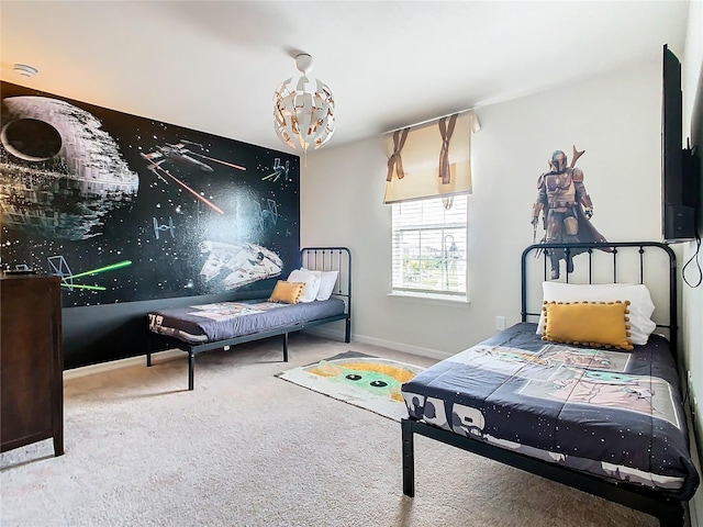 carpeted bedroom featuring an inviting chandelier