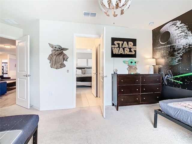 bedroom featuring light carpet and a chandelier