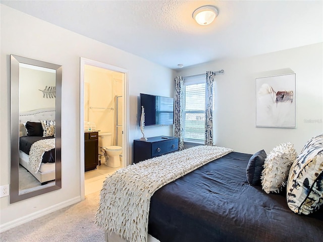 carpeted bedroom with connected bathroom