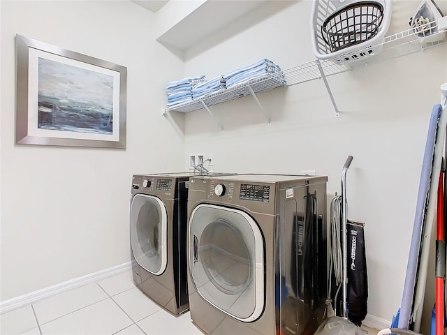 laundry area with light tile patterned floors and washer and dryer