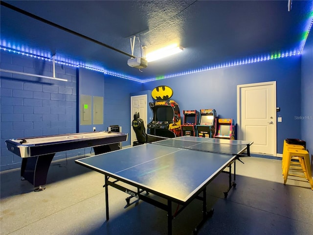 playroom with a textured ceiling and electric panel