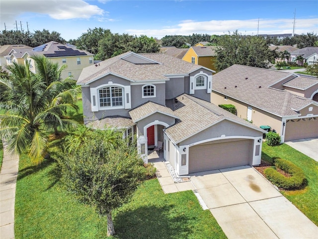 view of front of property featuring a front yard and a garage