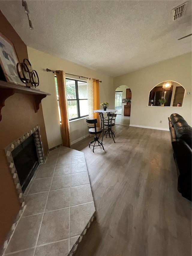 living room featuring a textured ceiling and hardwood / wood-style flooring