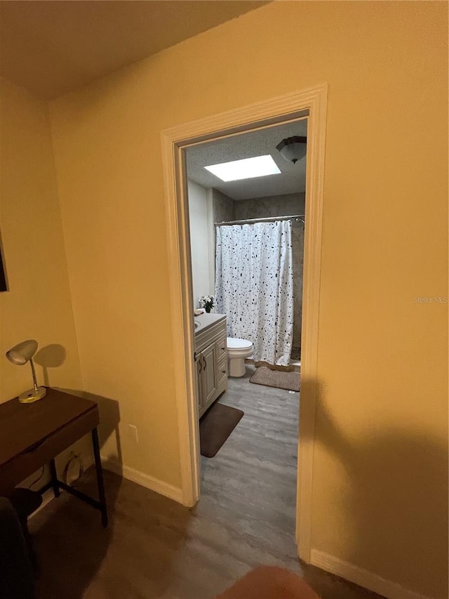 corridor featuring hardwood / wood-style floors