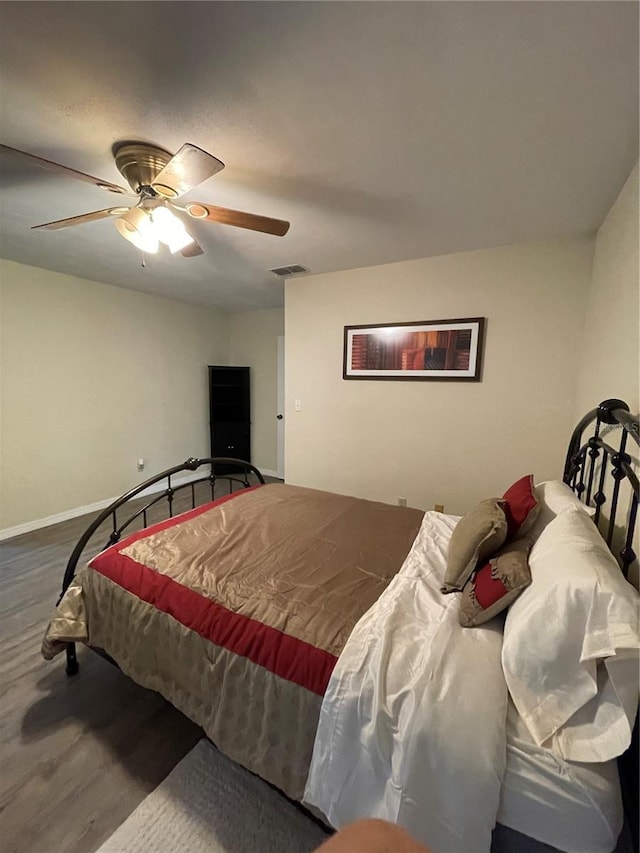 bedroom featuring hardwood / wood-style floors and ceiling fan