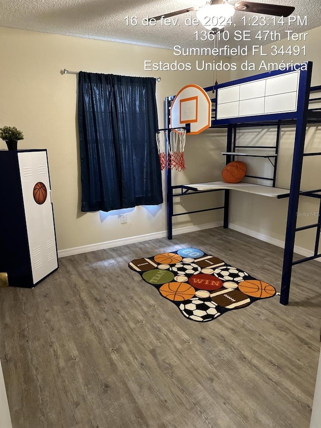 unfurnished bedroom featuring a textured ceiling and hardwood / wood-style flooring