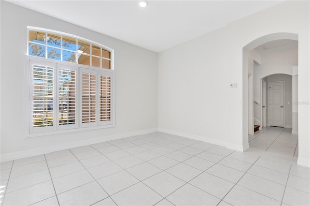 spare room featuring light tile patterned floors