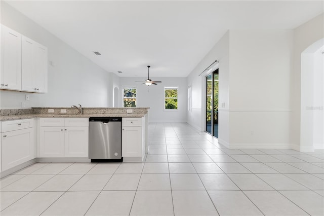 kitchen featuring ceiling fan, white cabinets, and stainless steel dishwasher