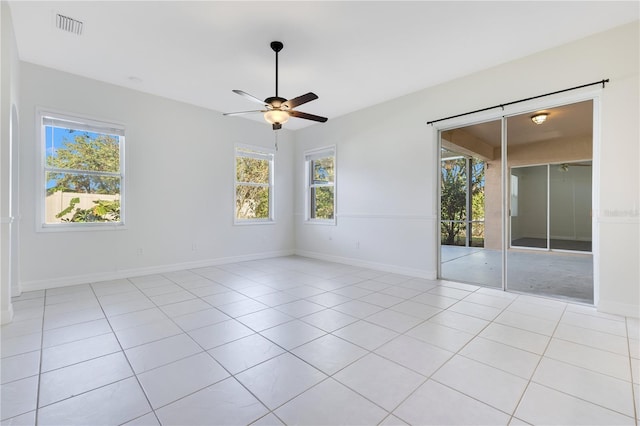 spare room with ceiling fan and light tile patterned flooring