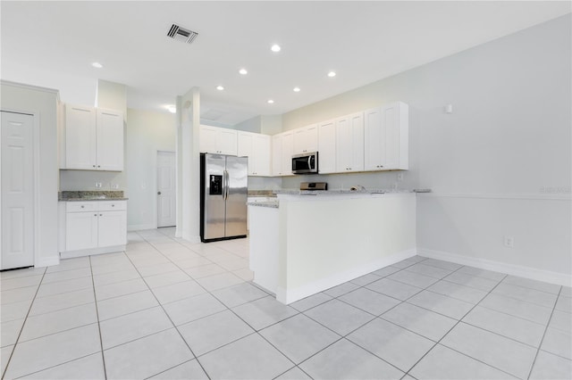 kitchen featuring kitchen peninsula, appliances with stainless steel finishes, white cabinets, and light tile patterned flooring