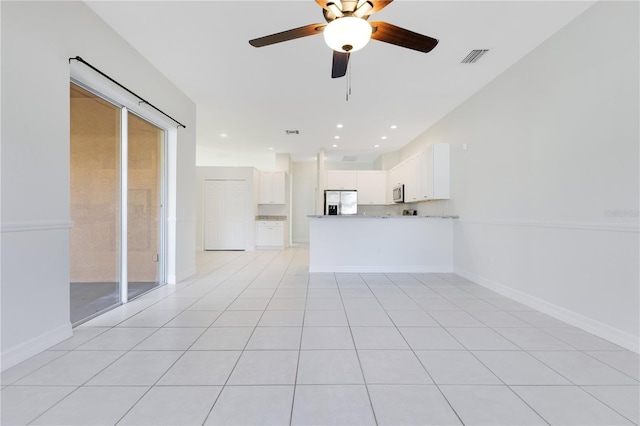 unfurnished living room with ceiling fan and light tile patterned floors