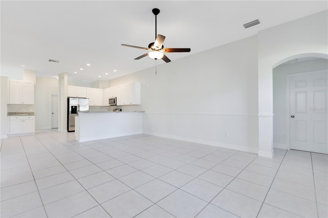 unfurnished living room featuring ceiling fan and light tile patterned flooring