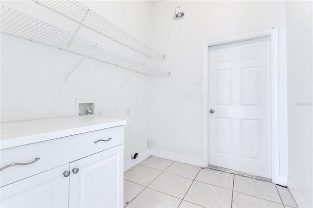 laundry room featuring hookup for a washing machine, light tile patterned flooring, cabinets, and hookup for an electric dryer