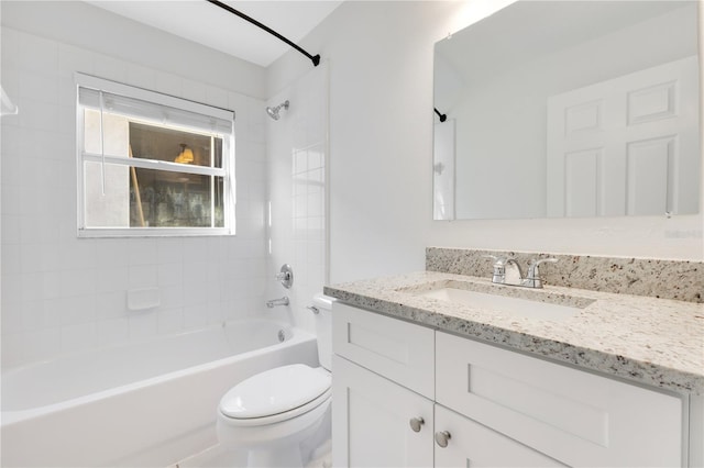 full bathroom with vanity, tiled shower / bath combo, and toilet