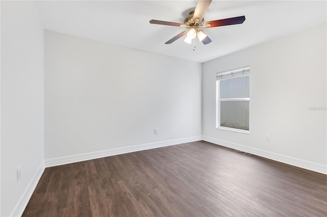 empty room with ceiling fan and dark wood-type flooring