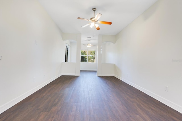 spare room with dark hardwood / wood-style floors and ceiling fan