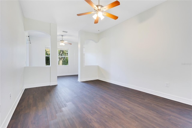 unfurnished room featuring ceiling fan and dark wood-type flooring