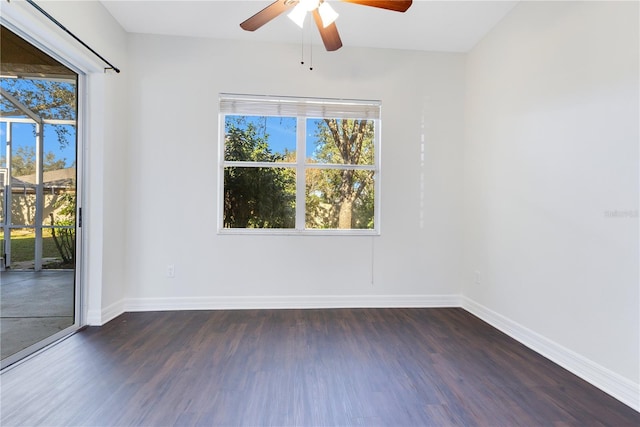 unfurnished room featuring dark hardwood / wood-style flooring, a wealth of natural light, and ceiling fan