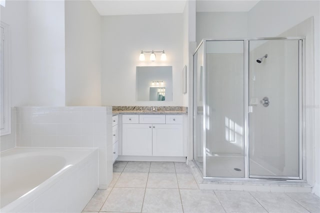 bathroom with tile patterned flooring, vanity, and independent shower and bath