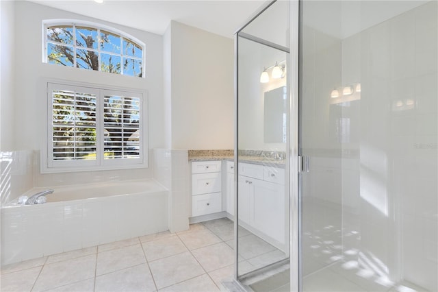 bathroom featuring tile patterned floors, vanity, and separate shower and tub