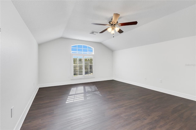 additional living space with vaulted ceiling, ceiling fan, and dark wood-type flooring