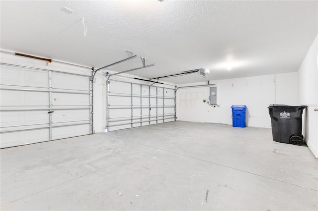 garage with electric panel and a garage door opener