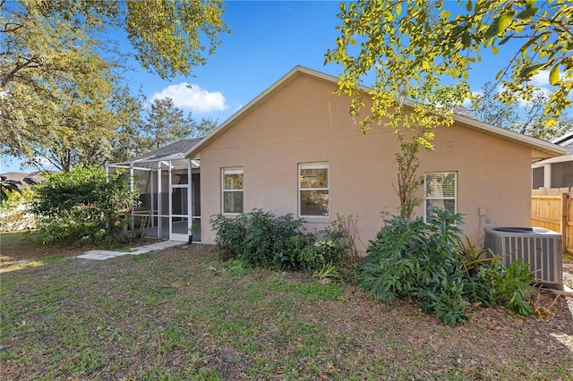 back of property with a lanai and cooling unit