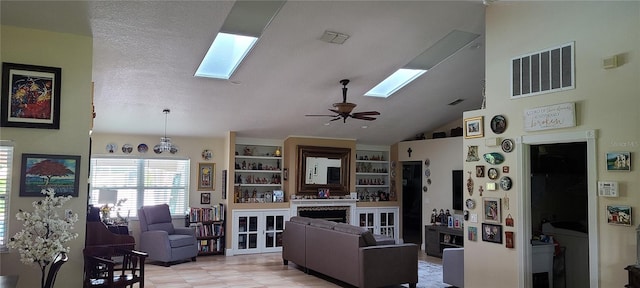 living room with a textured ceiling, high vaulted ceiling, and ceiling fan