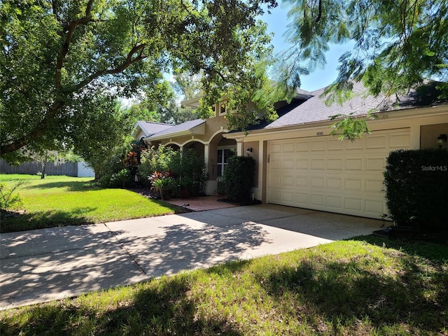 ranch-style house with a garage and a front lawn