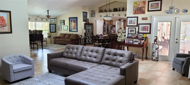 living room with ceiling fan, french doors, and vaulted ceiling