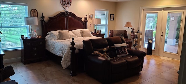 bedroom featuring french doors, multiple windows, and access to exterior