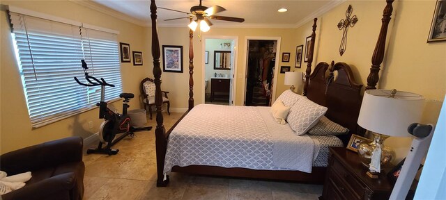 tiled bedroom featuring a walk in closet, ensuite bath, ceiling fan, ornamental molding, and a closet