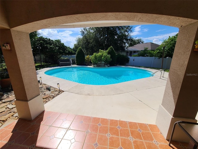 view of swimming pool featuring a fenced in pool, a patio area, and a fenced backyard