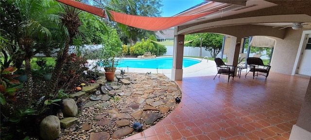 view of pool featuring ceiling fan and a patio area