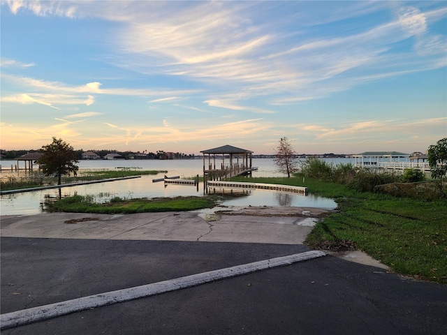 view of community with a water view and a boat dock