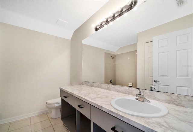 bathroom featuring tile patterned flooring, vanity, toilet, and a tile shower