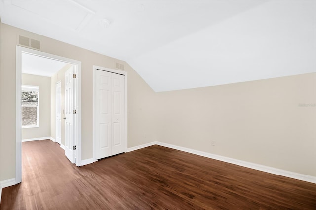 bonus room with dark hardwood / wood-style flooring and lofted ceiling