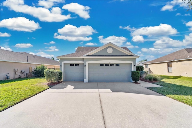 view of front of house featuring a front lawn and a garage