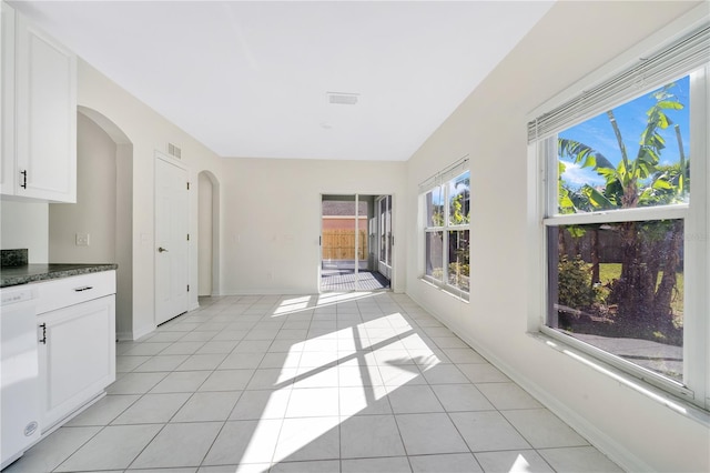 kitchen featuring white cabinetry, dishwasher, and light tile patterned flooring