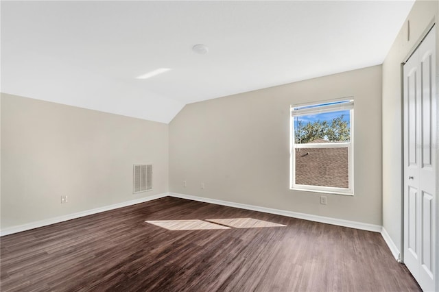 bonus room featuring dark hardwood / wood-style flooring and lofted ceiling