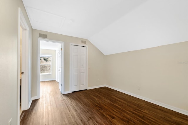 additional living space featuring dark hardwood / wood-style floors and lofted ceiling