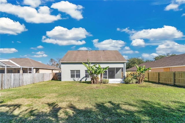 back of house featuring a sunroom and a yard