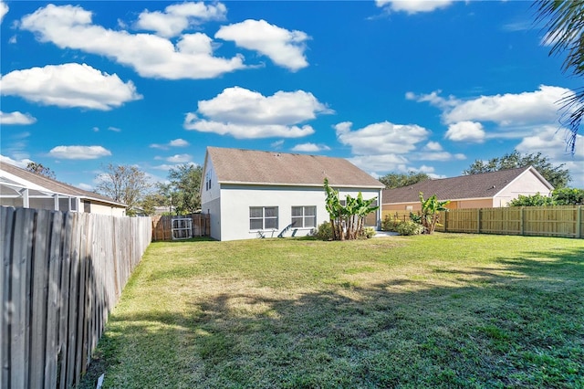 rear view of property featuring a lawn