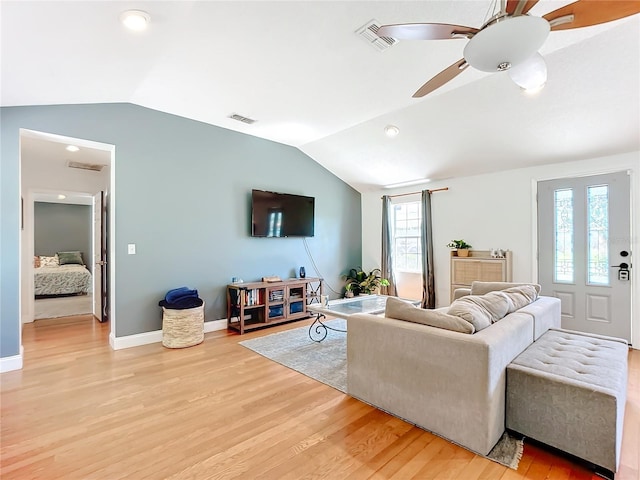 living room with vaulted ceiling, light hardwood / wood-style floors, and ceiling fan