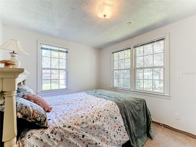 bedroom with a textured ceiling and carpet