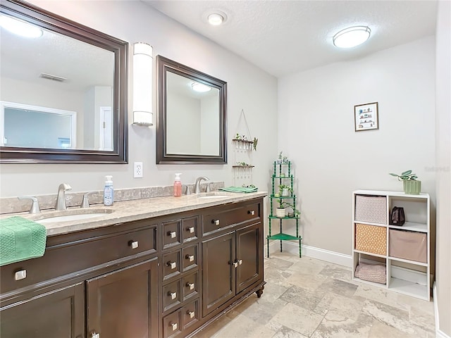 bathroom featuring vanity and a textured ceiling