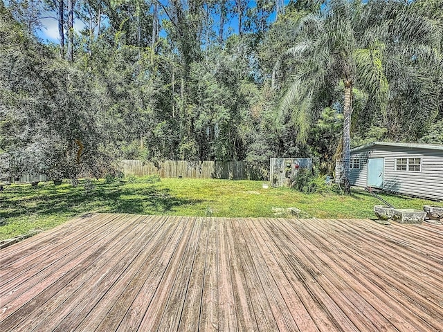 deck with a yard and a shed